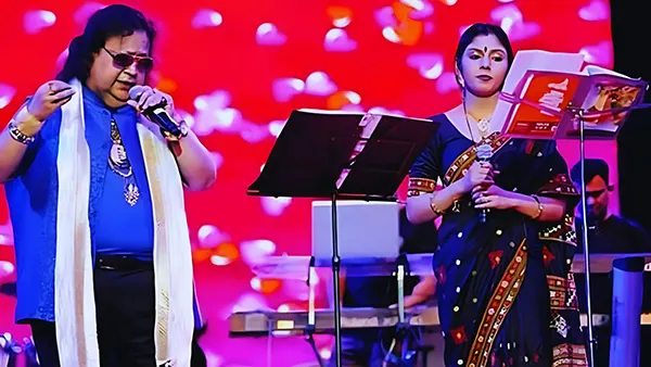Madhumita Chakraborty performing live on stage alongside the legendary singer and music director Bappi Lahiri during a musical concert, creating a memorable fusion of classical and contemporary melodies.