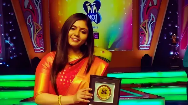 **Rewritten Version:** Madhumita Chakraborty proudly received the *Didi No. 1 Award* on the popular Zee Bangla show, celebrating her remarkable talent and contribution to music.